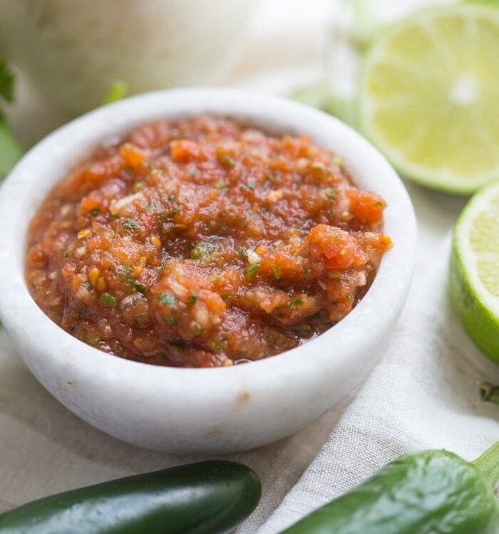 This is the best restaurant-style salsa recipe, and I've been making it blissfully for almost a decade! What makes this the best restaurant-style salsa recipe? Spoiler alert: it comes from one of my favorite Mexican restaurants (but I'll never say which)! It blends fresh garlic, cilantro, chiles, onions, and tomatoes with canned tomatoes for the perfect blend of fresh and traditional restaurant style salsa. So good!
