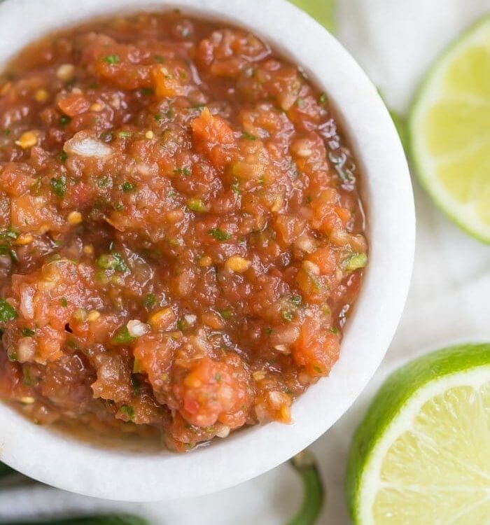 This is the best restaurant-style salsa recipe, and I've been making it blissfully for almost a decade! What makes this the best restaurant-style salsa recipe? Spoiler alert: it comes from one of my favorite Mexican restaurants (but I'll never say which)! It blends fresh garlic, cilantro, chiles, onions, and tomatoes with canned tomatoes for the perfect blend of fresh and traditional restaurant style salsa. So good!