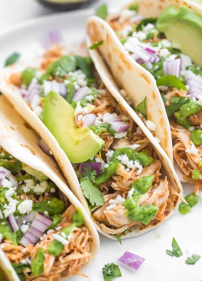 Close up of Crockpot chicken tacos with lots of toppings