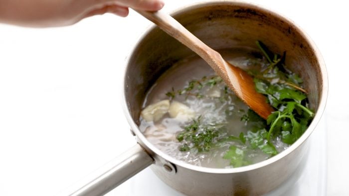 Combine your water, salt, garlic, and herbs in a saucepan and dissolve the salt completely. Bring to a boil.