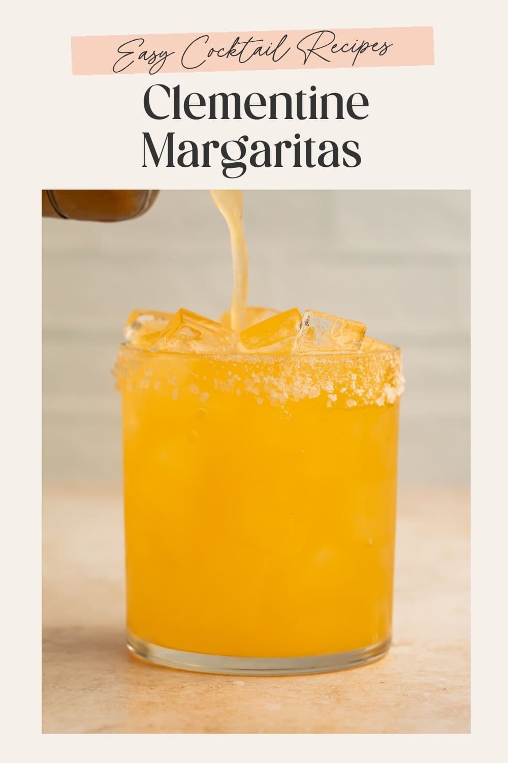 Orange margarita being poured into a rocks glass of ice. There is a frame on the image with Pinterest-optimized text.