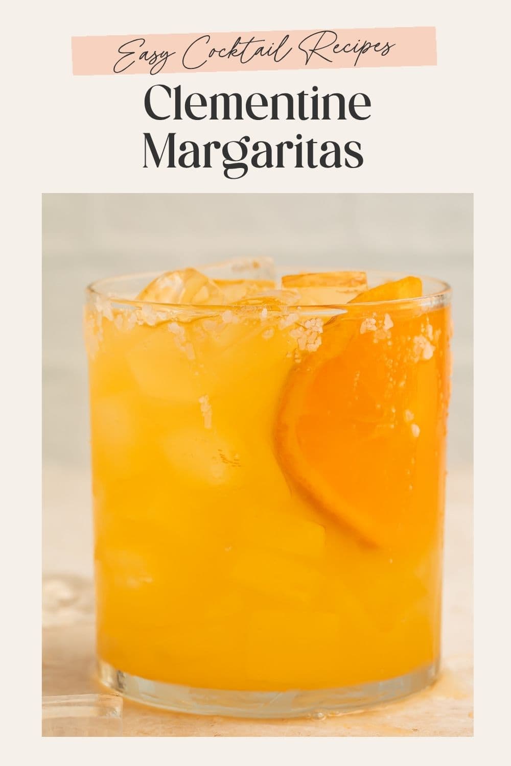 Close up of a clementine margarita with a pink frame on the image. The frame is overlaid with Pinterest-optimised text.