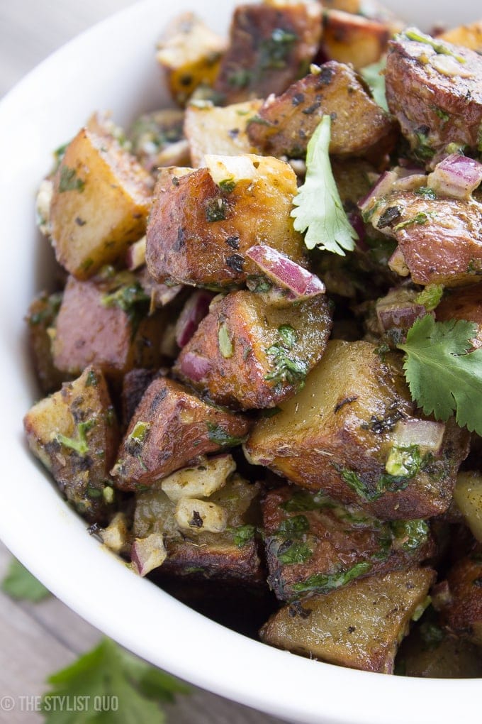 This herb-roasted potato salad is absolutely delicious: crispy roasted potatoes, heady dried herbs, and a rich and creamy sauce with fresh herbs and minced red onions. Packed full of flavor, this herb-roasted potato salad is destined to become a favorite, both with the family and with your guests! This herb-roasted potato salad is also paleo, Whole30-compliant, and vegan friendly. Simply put, it's the best herb-roasted potato salad out there.