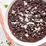 Bowl of refried black beans with queso fresco