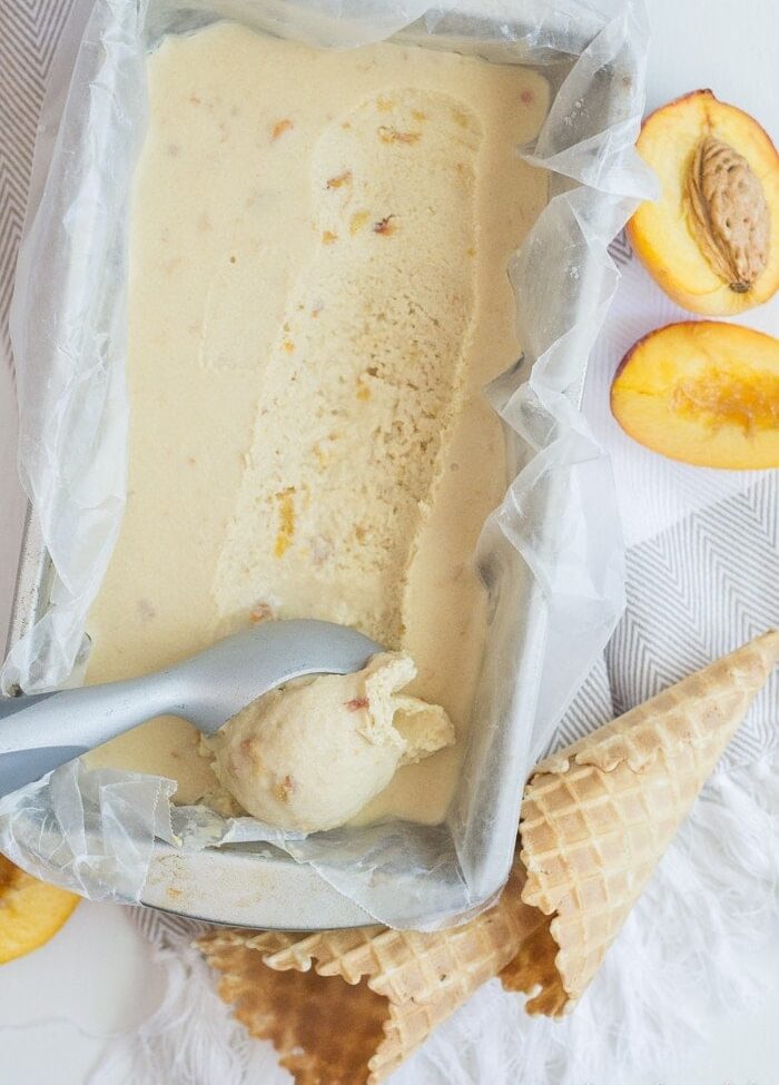 Vegan Peach Ice Cream. 7 ingredients, no refined sugars, no gluten. Just tons of peaches and coconut milk and summery goodness!
