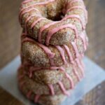 Baked apple cider donuts rolled in cinnamon sugar and topped with pomegranate glaze. Perfect for fall and so moist!