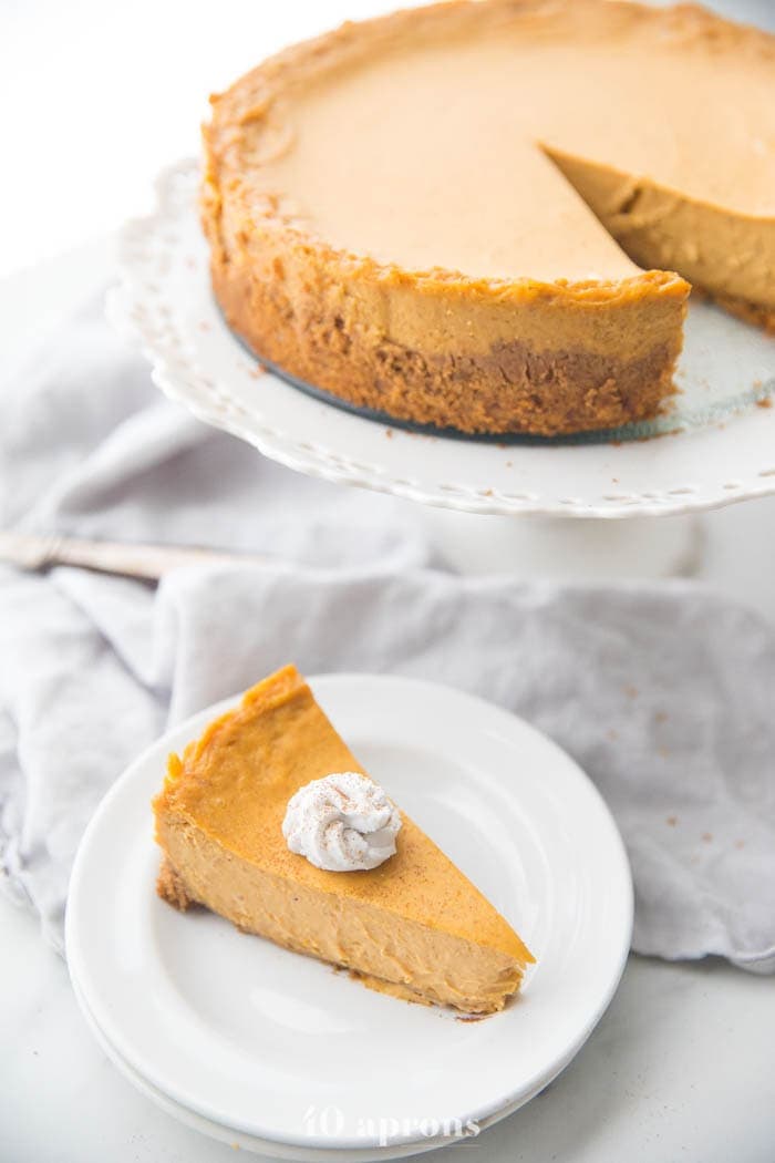 Vegan pumpkin cheesecake with whipped coconut cream on a plate