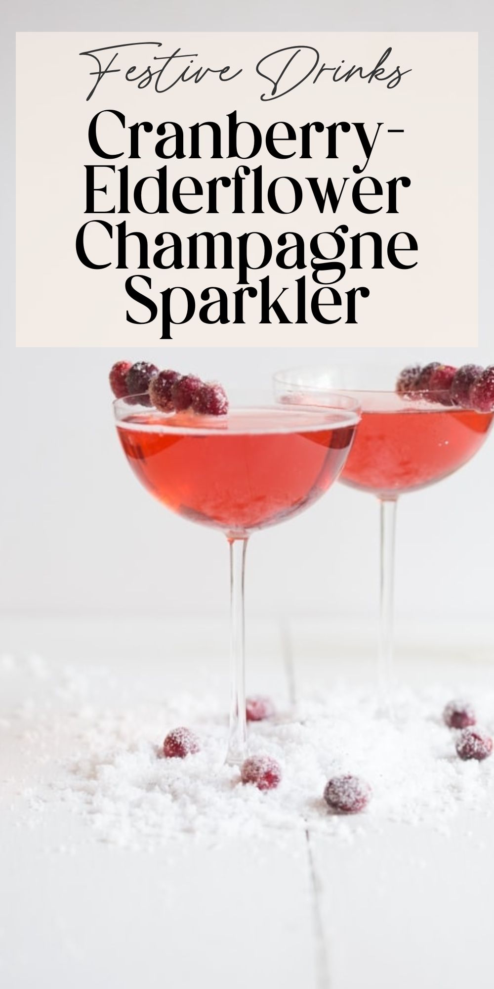 Festive drinks cranberry elderflower champagne sparkler recipe pin with two cocktails and sugared cranberries.
