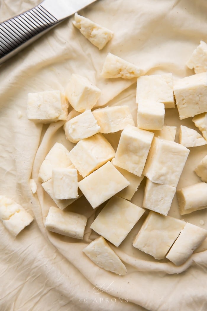 Cubes of homemade paneer Indian cheese on cheesecloth