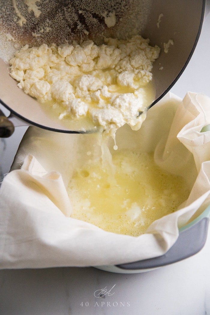 Pouring curds into a colander