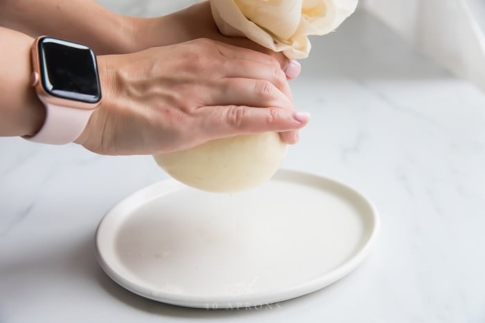 Squeezing whey out of curds