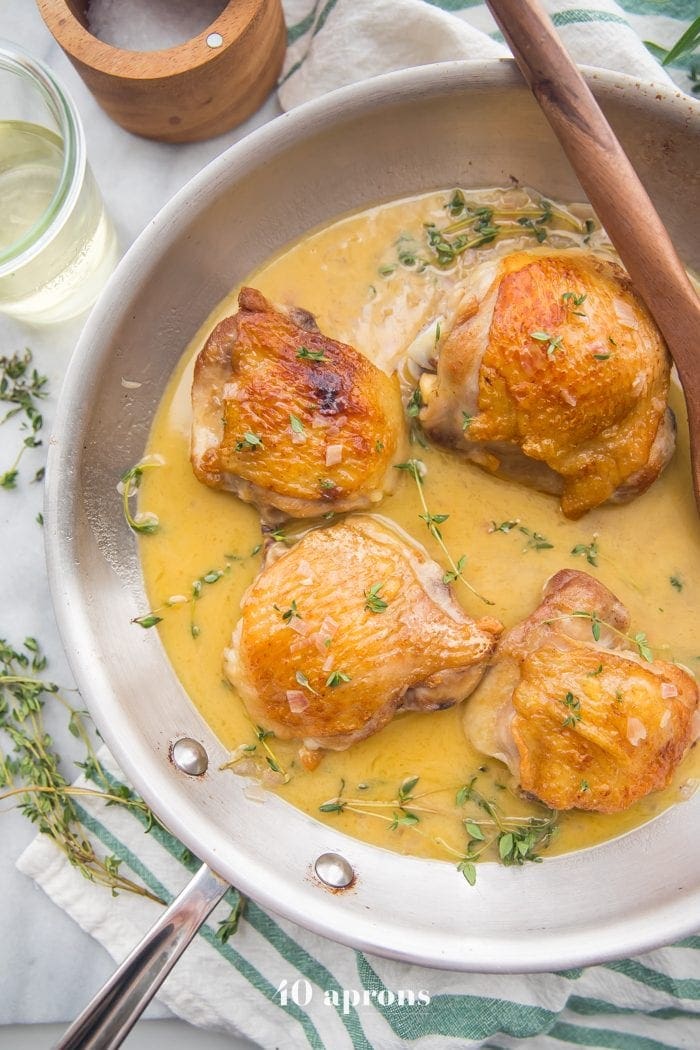 Perfect pan seared chicken thighs with pan sauce in a skillet 