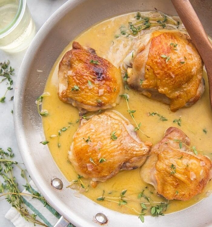 Perfect pan seared chicken thighs with pan sauce in a skillet
