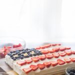 Flag Cake with Whipped Cream Frosting & Bunny Grahams // Rich yellow cake with a whipped cream-cream cheese frosting, finished with fresh fruit and sweet Bunny Grahams. Happy 4th of July, you beautiful patriot, you.