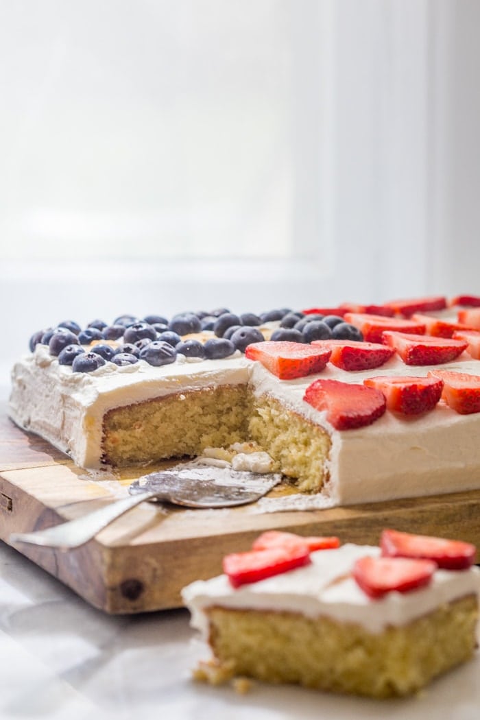 Flag Cake with Whipped Cream Frosting & Bunny Grahams // Rich yellow cake with a whipped cream-cream cheese frosting, finished with fresh fruit and sweet Bunny Grahams. Happy 4th of July, you beautiful patriot, you.