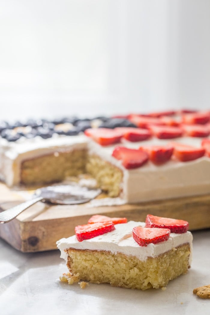 Flag Cake with Whipped Cream Frosting & Bunny Grahams // Rich yellow cake with a whipped cream-cream cheese frosting, finished with fresh fruit and sweet Bunny Grahams. Happy 4th of July, you beautiful patriot, you.