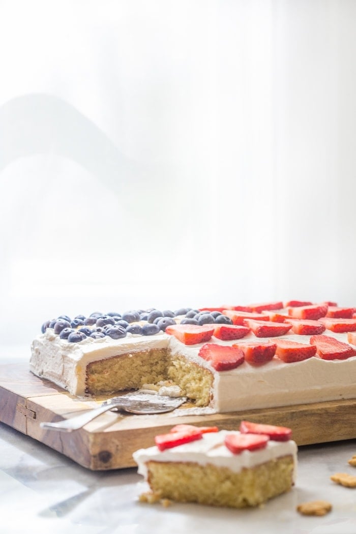 Flag Cake with Whipped Cream Frosting & Bunny Grahams // Rich yellow cake with a whipped cream-cream cheese frosting, finished with fresh fruit and sweet Bunny Grahams. Happy 4th of July, you beautiful patriot, you.