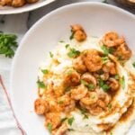 Whole30 healthy shrimp and grits in a bowl with skillet to the side