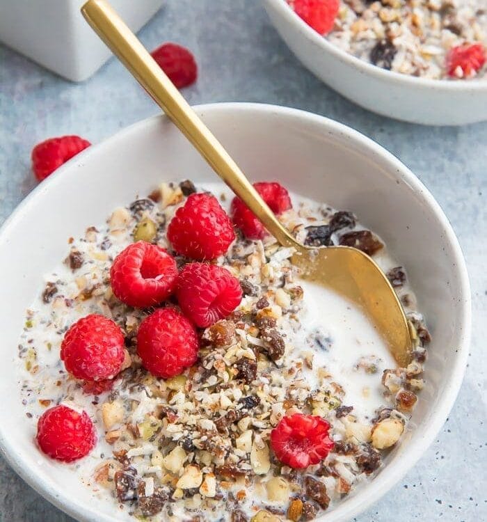 Two bowls of paleo cereal topped with raspberries