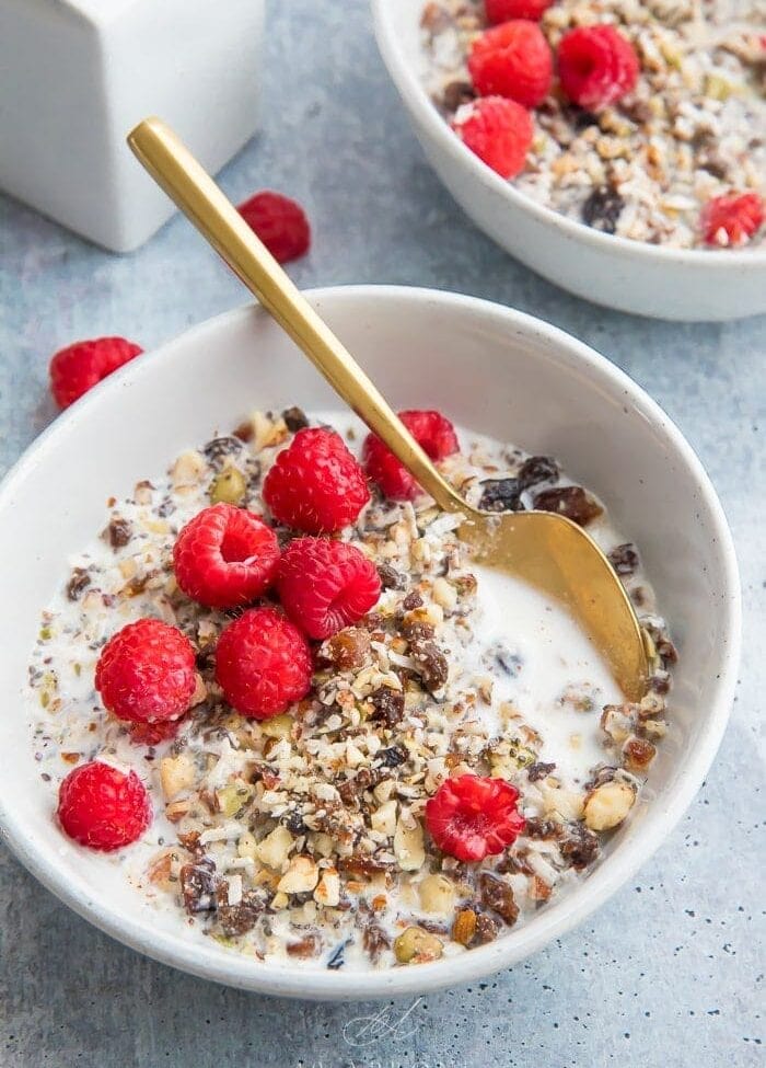 Two bowls of paleo cereal topped with raspberries