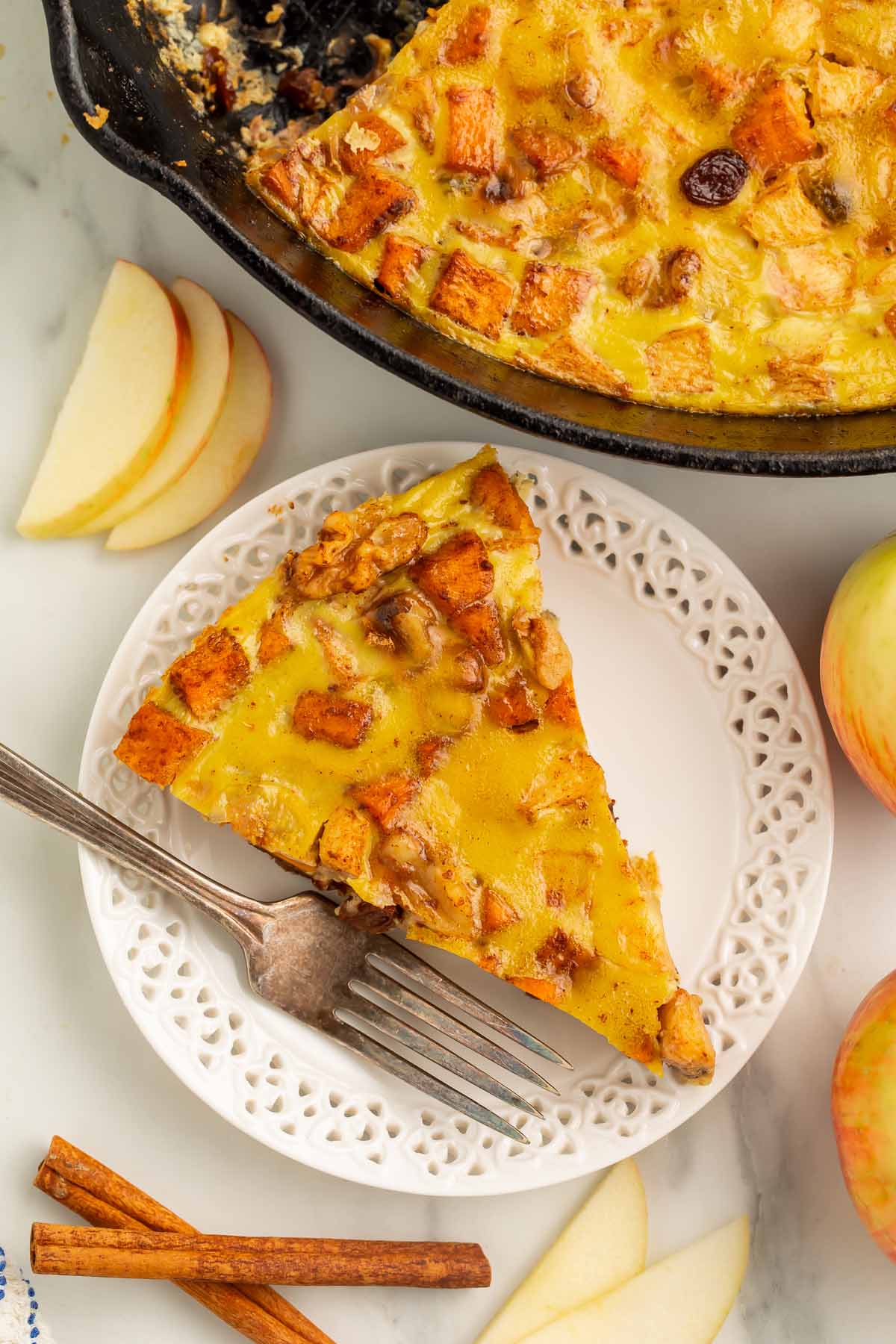 A triangular wedge of paleo breakfast bake on a small white plate with a fork.