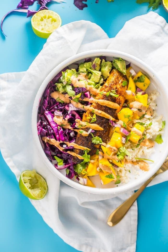 Whole30 fish taco bowl with mango salsa, chipotle aioli, and coconut-lime cauliflower rice