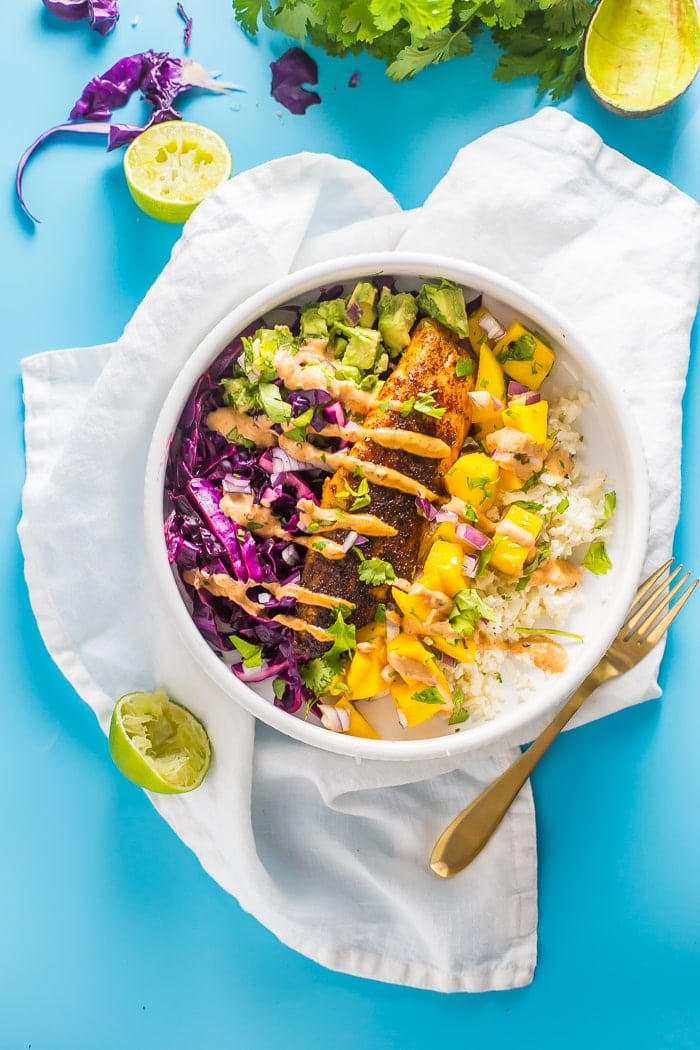 These Whole30 fish taco bowls with mango salsa and chipotle aioli make an absolutely wonderful Whole30 dinner. Loaded with guacamole, mango salsa, red cabbage slaw, coconut-lime cauliflower rice, and spicy chipotle aioli, I promise this will become your favorite paleo fish recipe or Whole30 fish recipe. Pinky promise! This Whole30 fish taco bowls recipe is gluten-free, dairy-free, grain-free, and sugar-free. Nothin' fishy about it (SORRY!).