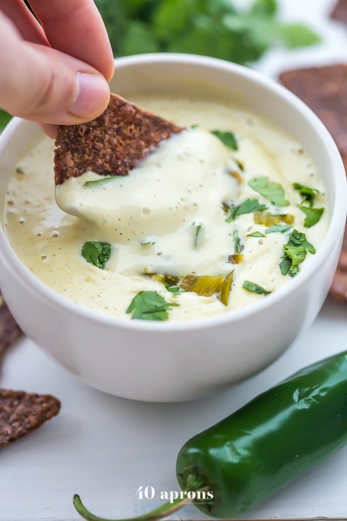 This is the best vegan queso recipe ever, and I will challenge you to a duel to prove it! ⚔ Well, maybe I'll just make these vegan queso for you instead... My child needs me to live! But one bite, and you'll be convinced. With rich cashew cream, bright green chiles, and spicy jalapenos, you'll fall in love with this vegan queso and finally get nachos into the weekly dinner rotation. This recipe is a paleo queso blanco, too, so long as you don't mind potatoes.