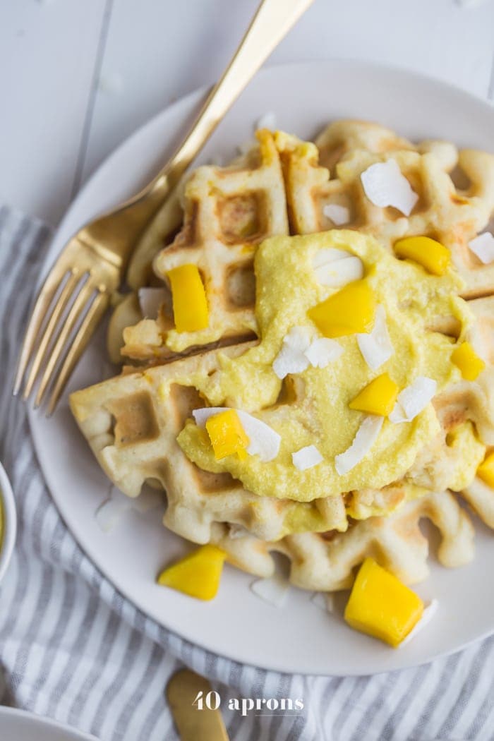 These are the best paleo waffles, topped with sweet mango cream. They're tender and light, sweet and flavorful. Topped with a sweet mango cream made from healthy, real ingredients, this dish will become your favorite paleo breakfast recipe! And if you're asking me, this is the best paleo waffle recipe - the texture is light and fluffy, but you'll feel energized instead of sluggish after a stack. Perfect for spring and summer!