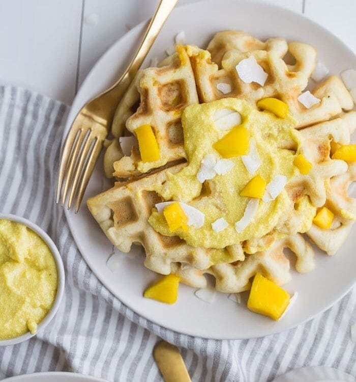 These paleo coconut waffles with sweet mango cream are tender and light, sweet and flavorful. Topped with a sweet mango cream made from healthy, real ingredients, this dish will become your favorite paleo breakfast recipe! And if you're asking me, this is the best paleo waffle recipe - the texture is light and fluffy, but you'll feel energized instead of sluggish after a stack. Perfect for spring and summer!