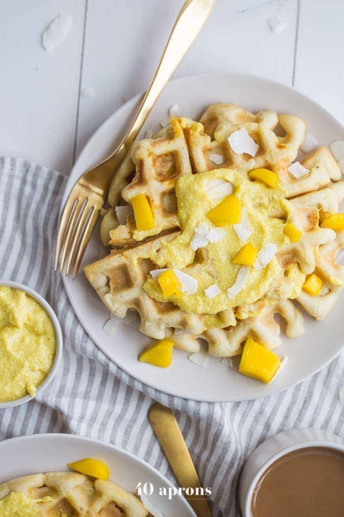 These paleo coconut waffles with sweet mango cream are tender and light, sweet and flavorful. Topped with a sweet mango cream made from healthy, real ingredients, this dish will become your favorite paleo breakfast recipe! And if you're asking me, this is the best paleo waffle recipe - the texture is light and fluffy, but you'll feel energized instead of sluggish after a stack. Perfect for spring and summer!