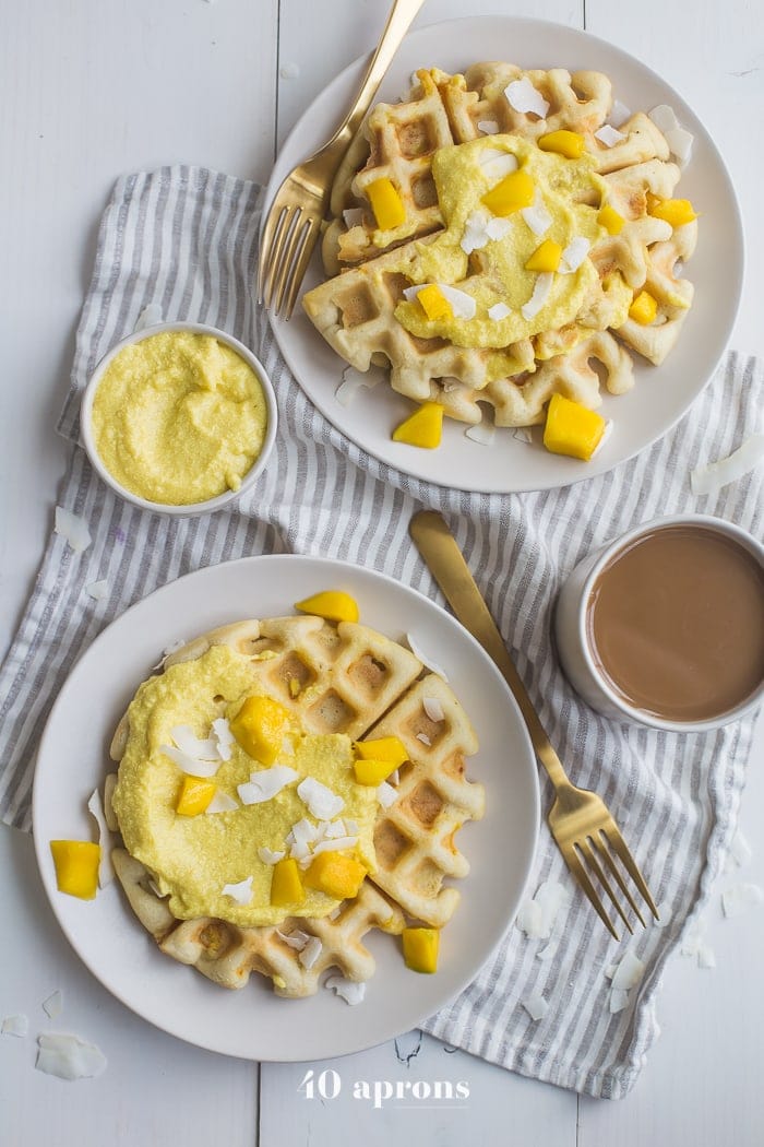 These are the best paleo waffles, topped with sweet mango cream. They're tender and light, sweet and flavorful. Topped with a sweet mango cream made from healthy, real ingredients, this dish will become your favorite paleo breakfast recipe! And if you're asking me, this is the best paleo waffle recipe - the texture is light and fluffy, but you'll feel energized instead of sluggish after a stack. Perfect for spring and summer!