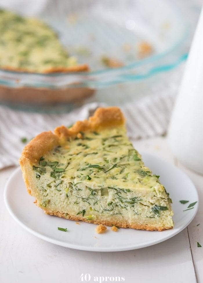 This paleo quiche with crab and spinach is a fantastic paleo Mother's Day brunch recipe, but it's versatile and quick enough to become a favorite paleo dinner or paleo brunch dish in your rotation. With an almond flour crust, this paleo quiche is so much like a cheesy, gluteny quiche!