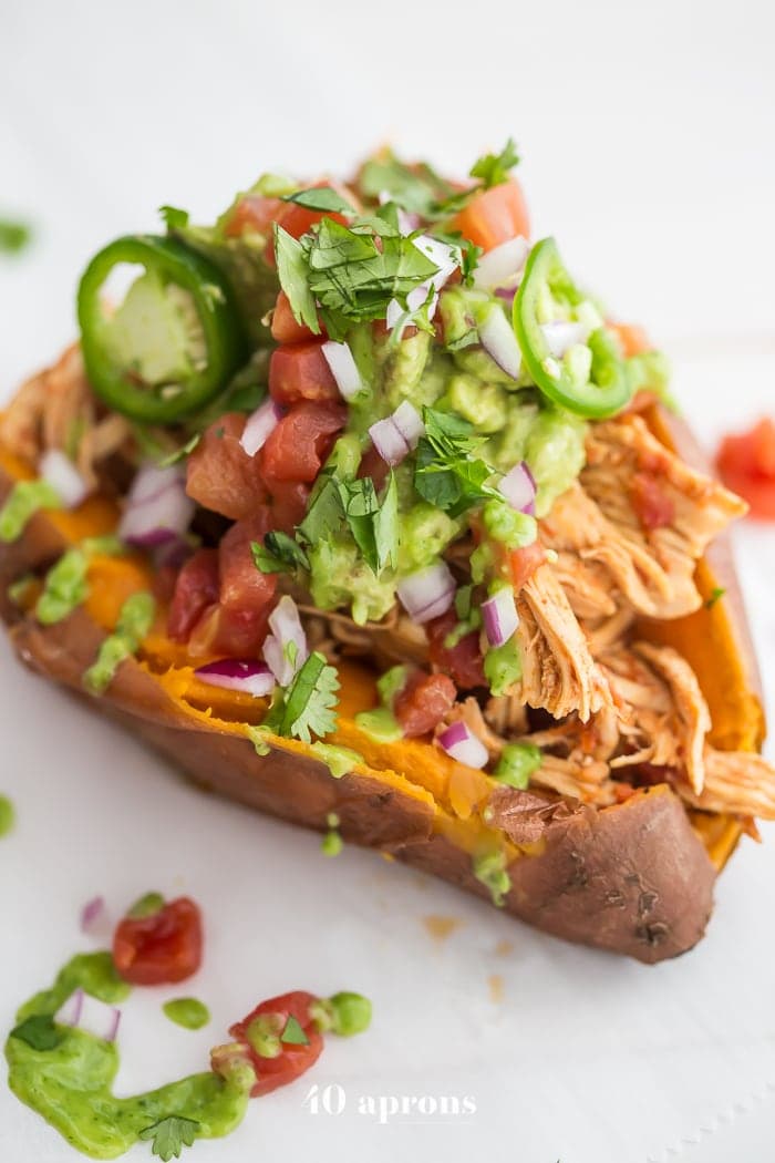 These Whole30 Instant Pot Mexican stuffed sweet potatoes with chicken are the perfect Whole30 dinner: insanely full of flavor, filling, and full of protein, fiber, and healthy fats. Your new go-to Whole30 Mexican recipe! A great anytime paleo Mexican dinner, too.