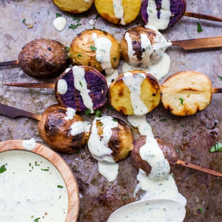 One of the best red, white, and blue side dishes! These grilled red, white, and blue potato skewers with ranch dressing are the perfect patriotic side dish. Garlicky, packed with flavor, and festive yet elegant, they go so well with burgers or brauts on the grill! One of the best red, white, and blue side dishes, these Whole30 potato skewers with ranch dressing are just delicious.