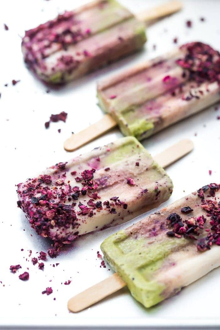 These mermaid popsicles layer a creamy coconut matcha mixture with a sweet coconut cream and honey roasted blackberries. Perfect for a mermaid party or mermaid birthday party, these stunning paleo popsicles are surprisingly easy. One of my favorite paleo popsicle recipes or vegan popsicle recipes, these mermaid popsicles are just too much fun! Made with the best popsicle mold and my favorite matcha powder.