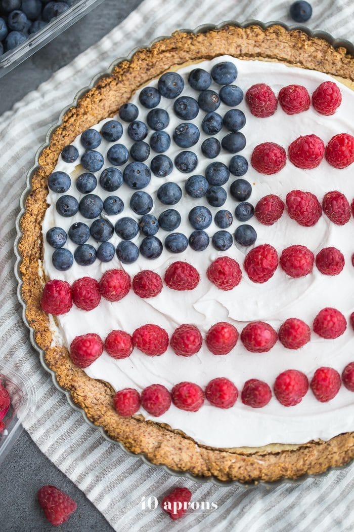 This paleo flag fruit tart is Fourth of July dessert perfection. With a coconut oil shortbread crust, rich almond frangiapane filling, and topped with cool coconut cream and fresh fruit, you've got your paleo Fourth of July dessert covered. Why make a paleo 4th of July cake when you can make a tart delicious enough to beat all other paleo 4th of July desserts?! U-S-A! U-S-A!