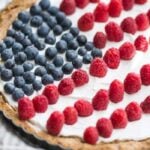 This paleo flag fruit tart is Fourth of July dessert perfection. With a coconut oil shortbread crust, rich almond fangiapane filling, and topped with cool coconut cream and fresh fruit, you've got your paleo Fourth of July dessert covered. Why make a paleo 4th of July cake when you can make a tart delicious enough to beat all other paleo 4th of July desserts?! U-S-A! U-S-A!