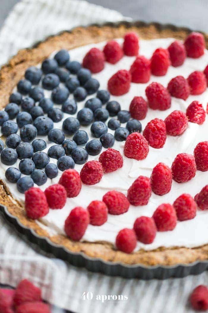 This paleo flag fruit tart is Fourth of July dessert perfection. With a coconut oil shortbread crust, rich almond fangiapane filling, and topped with cool coconut cream and fresh fruit, you've got your paleo Fourth of July dessert covered. Why make a paleo 4th of July cake when you can make a tart delicious enough to beat all other paleo 4th of July desserts?! U-S-A! U-S-A!