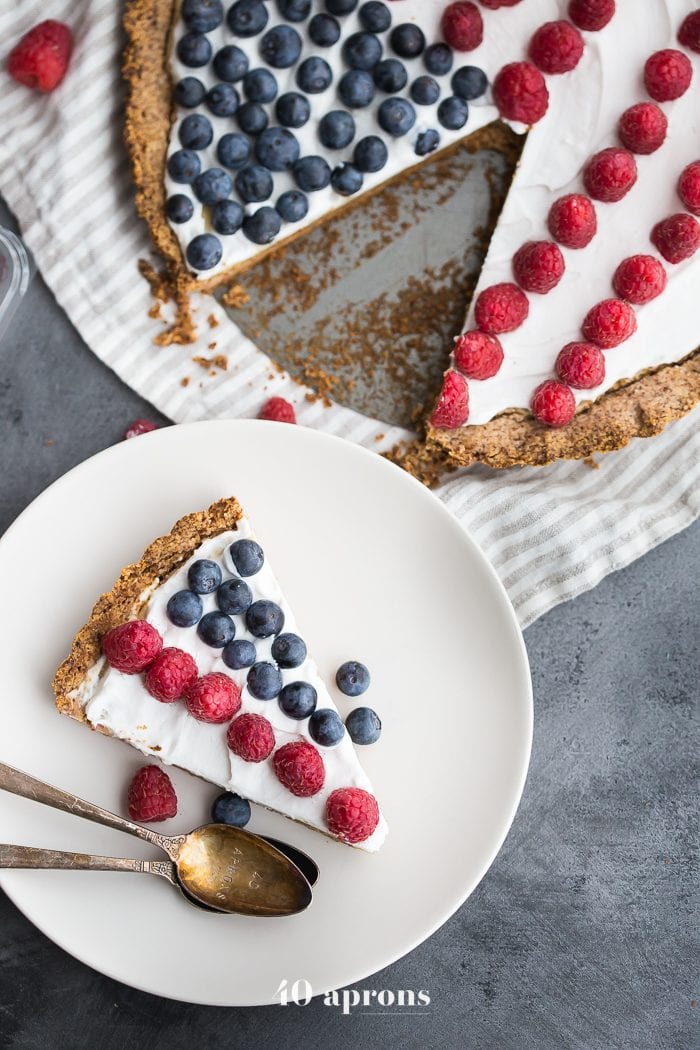 This paleo flag fruit tart is Fourth of July dessert perfection. With a coconut oil shortbread crust, rich almond frangiapane filling, and topped with cool coconut cream and fresh fruit, you've got your paleo Fourth of July dessert covered. Why make a paleo 4th of July cake when you can make a tart delicious enough to beat all other paleo 4th of July desserts?! U-S-A! U-S-A!