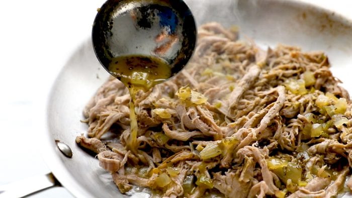 Brown carnitas in skillet and drizzle with cooking juice