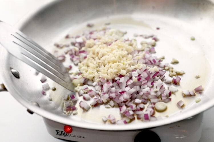 Red onion and garlic in a large skillet with sesame oil.