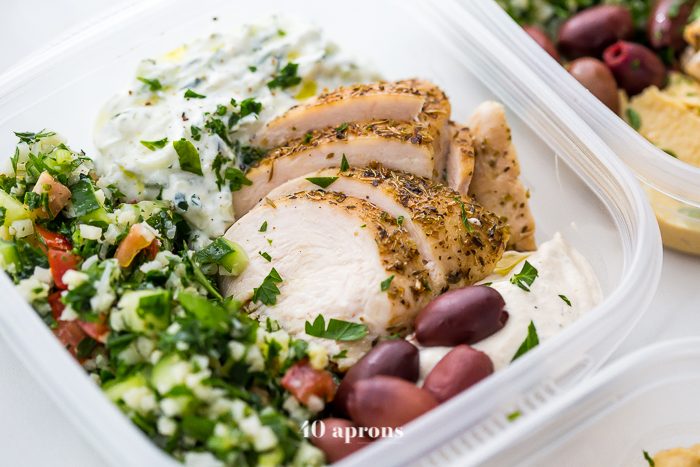 This Greek healthy meal prep recipe is epic: cauliflower rice tabbouleh, tender seasoned chicken breasts, hummus or baba ganoush, kalamata olives, and a rich, garlicky tzatziki. This healthy meal prep recipe will have you looking forward to lunch all morning! It's also a Whole30 meal prep recipe and paleo meal prep recipe, too, when you sub coconut cream or coconut yogurt for the yogurt. This is seriously SUCH a perfect healthy meal prep recipe.