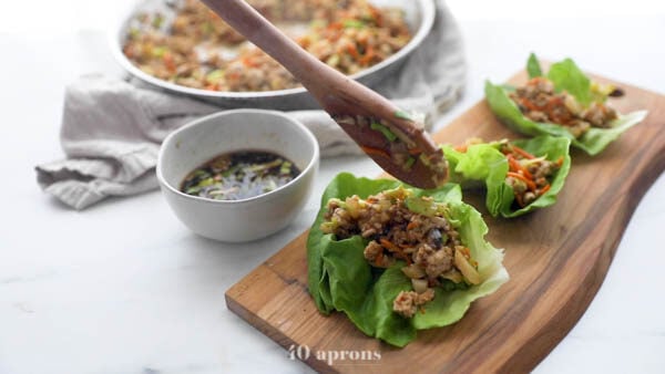 Spoon mixture into lettuce cups and serve with sauce