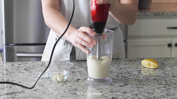 Work immersion blender up through oil mixture