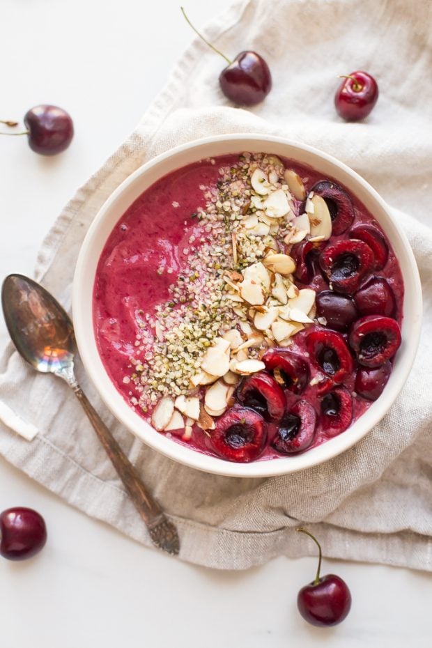 overhead shot of cherry smoothie bowl topped with vegan protein source hemp hearts
