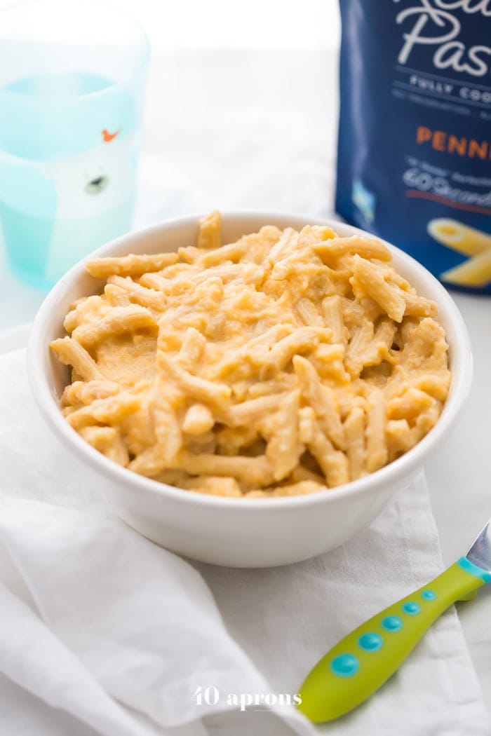 This quick hidden veggie mac and cheese comes together in only 5 minutes and gets its creaminess from veggies! The perfect toddler mac and cheese, this quick hidden veggie mac and cheese is healthier and way better than boxed! Made with frozen cauliflower rice and carrots, Barilla Ready Pasta, and a bit of cheddar cheese, this quick hidden veggie mac and cheese will become a staple in yours kids' diets.
