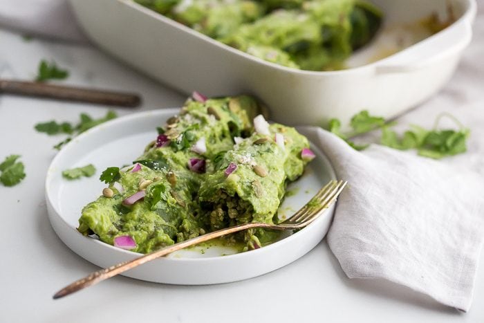 These Whole30 enchiladas are out of control! Stuffed with a roasted poblano pepper and ground pork mixture, seasoned with a, wait for it... cilantro-spinach-pepita pesto and plenty of mushrooms, they're the perfect Whole30 enchiladas recipe and they make a fantastic Whole30 dinner recipe. Topped with a rich, creamy avocado-cilantro sauce, you've got the best Whole30 enchiladas recipe ever... or maybe the best Whole30 dinner recipe ever? You decide. 