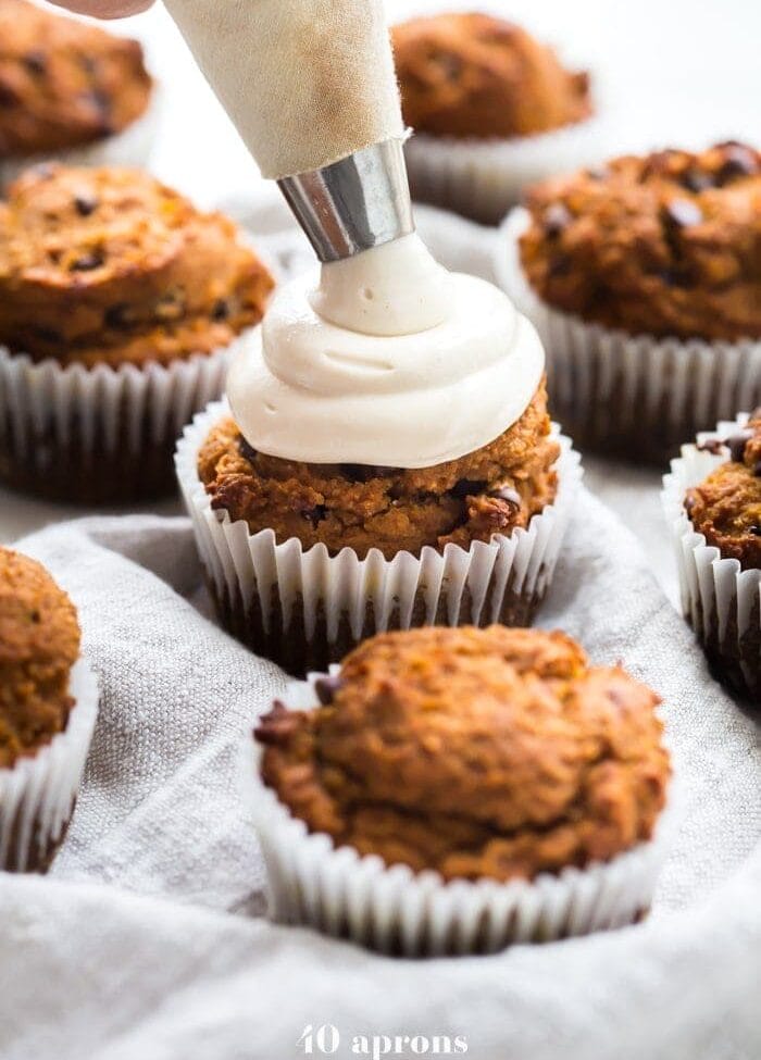 These paleo pumpkin chocolate chip muffins with cream cheese frosting are the perfect paleo fall recipe or paleo pumpkin recipe! They're moist and tender, loaded with pumpkin purée, dairy-free chocolate chips, and topped with a tangy but sweet frosting. And yep, they're entirely paleo. These paleo pumpkin chocolate chip muffins with cream cheese frosting are actually easy to make, too, so they'll become your very favorite paleo fall recipe or paleo pumpkin recipe for sure!