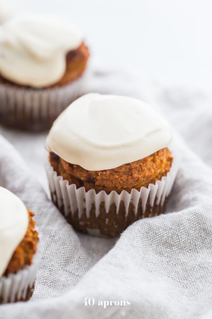These paleo pumpkin chocolate chip muffins with cream cheese frosting are the perfect paleo fall recipe or paleo pumpkin recipe! They're moist and tender, loaded with pumpkin purée, dairy-free chocolate chips, and topped with a tangy but sweet frosting. And yep, they're entirely paleo. These paleo pumpkin chocolate chip muffins with cream cheese frosting are actually easy to make, too, so they'll become your very favorite paleo fall recipe or paleo pumpkin recipe for sure!